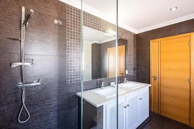 a large bathroom with a tub and a sink at VILLA Simao in Guia