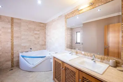 a kitchen with wooden cabinets and a stainless steel refrigerator at VILLA Simao in Guia