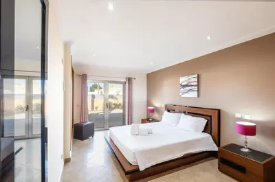 a bedroom with a large bed and a window at VILLA Simao in Guia