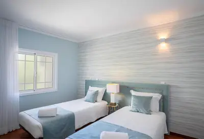 a swimming pool with lounge chairs and a swimming pool at London Old Town Apartment in Albufeira