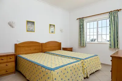 a bedroom with a bed and a window at Albufeira Marina Villa by Umbral in Albufeira