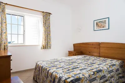 a bedroom with a bed and a window at Albufeira Marina Villa by Umbral in Albufeira