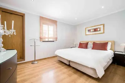 a bedroom with a large white bed with red pillows at Stunning 3 bed Villa in Vale do Lobo with Resort Membership 3 mins From Beach and Golf in Loulé