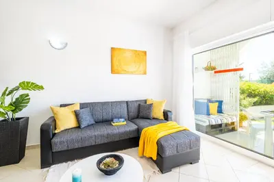 a living room with a gray couch and yellow pillows at Apartment Venice by Algarve Vacation in Albufeira