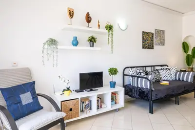 a living room with a bed and a tv at Apartment Venice by Algarve Vacation in Albufeira