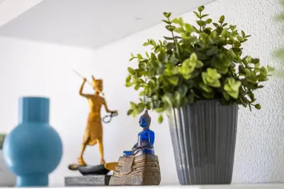 a vase with a plant and figurines on a shelf at Apartment Venice by Algarve Vacation in Albufeira