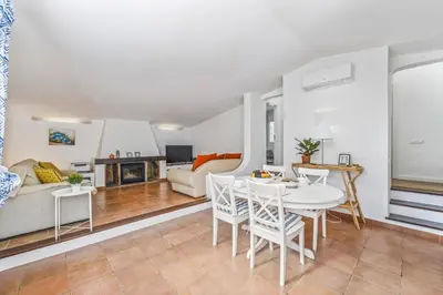 a living room with a white table and chairs at Villa Balaia by Villa Plus in Olhos de Água