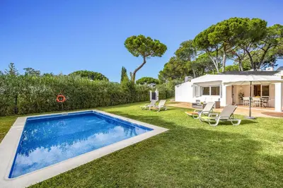 a yard with a swimming pool and a house at Villa Balaia by Villa Plus in Olhos de Água