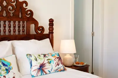 a bedroom with a bed with a wooden headboard and a lamp at Apartments in Albufeira - Old Town in Albufeira