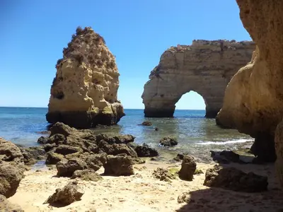 an arch in the rocks on the beach at Casal dos Machados - Vista Mar in Benfarras
