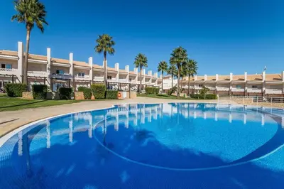 a large swimming pool in front of a building at Fantastic Townhouse with Pool and Sea Views in Albufeira