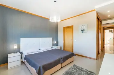 a bedroom with a large bed in a room at Fantastic Townhouse with Pool and Sea Views in Albufeira
