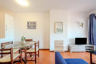 a dining room with a table and chairs and a tv at Apartamento LIMA by Sunnyway in Albufeira