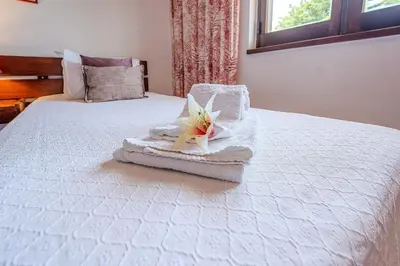 a white bed with a towel with a starfish on it at Apartamento LIMA by Sunnyway in Albufeira