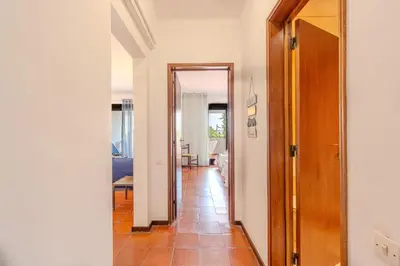 a hallway with a door leading to a living room at Apartamento LIMA by Sunnyway in Albufeira