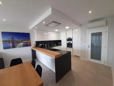 a kitchen with a counter and a dining room at @Rocking Apartments - Quinta da Alvorada in Albufeira