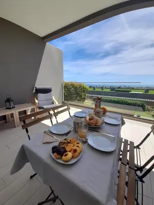 a table with plates of food on top of a balcony at @Rocking Apartments - Quinta da Alvorada in Albufeira