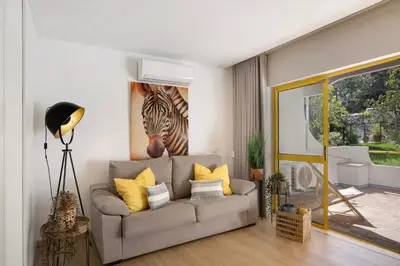 a living room with a couch and a painting of a zebra at África Minha in Vilamoura