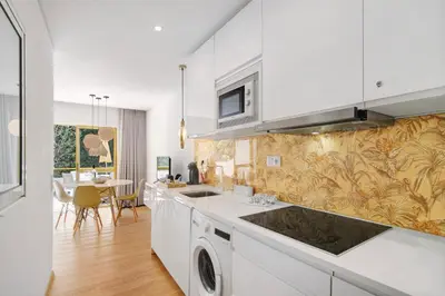 a kitchen with a sink and a stove at África Minha in Vilamoura