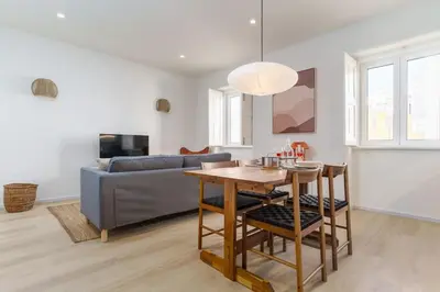 a living room with a couch and a table at Modern & Cozy Faro Mercado Apt 11 by Lisbeyond in Faro
