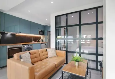 a living room with a couch and a table at Cosy Loft in Vilamoura in Vilamoura