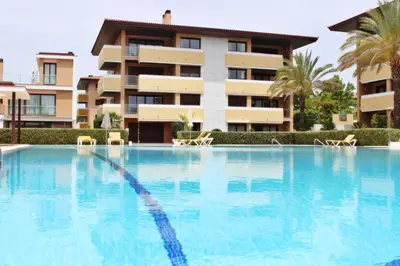 a large swimming pool in front of a building at Monte Laguna Apartment in Quarteira