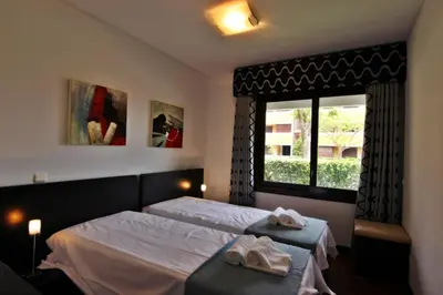 a bedroom with two beds and a window at Monte Laguna Apartment in Quarteira