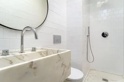 a bathroom with a sink and a mirror and a toilet at Modern & Cozy Faro Mercado Apt 21 by Lisbeyond in Faro
