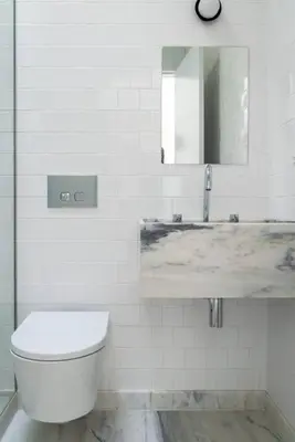 a white bathroom with a toilet and a sink at Modern & Bright - Faro Mercado Apt 22 by Lisbeyond in Faro