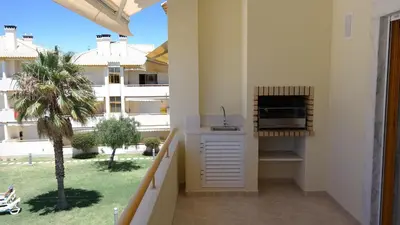 a balcony with a kitchen with a view of a building at Vila Atlantida Apartment in Vilamoura