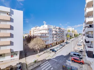 an overhead view of a city street with parked cars at AL - Apartamento Quarteira Avenida in Quarteira