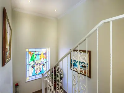 a hallway with a staircase with a stained glass window at Luxury Holiday Villa Pescadinha near Beach, Albufeira in Albufeira