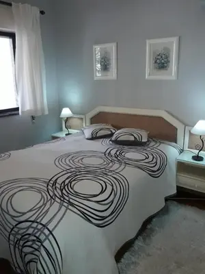 a large bed with a swirl design on it at Apartamentos Mar-Bel Sol in Vilamoura