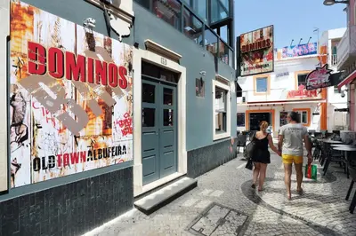 a man and a woman walking down a street at Original Studio Downtown in Albufeira