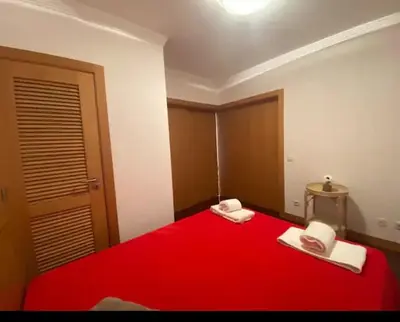 a small bedroom with two beds and a wall at Casa Maria in Albufeira