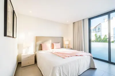 a bedroom with a bed and a large window at Villa Aboim - BY BEDZY in Guia
