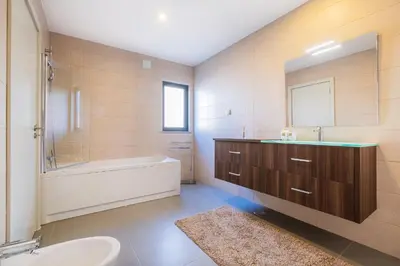 a bathroom with a tub and a sink and a bath tubermottermott at Villa Aboim - BY BEDZY in Guia