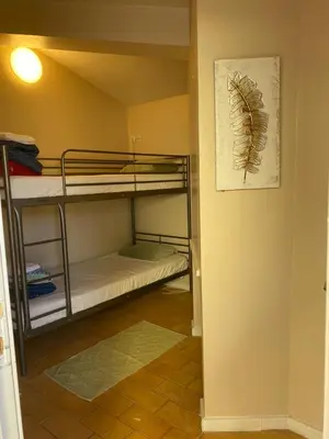 a room with bunk beds and a picture of a feather on the wall at Suites & Beds DP Albufeira in Albufeira