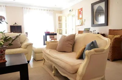 a living room with a couch and two chairs at Suites & Beds DP Albufeira in Albufeira
