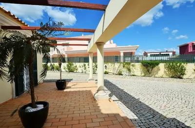 a patio with two potted plants and a building at Suites & Beds DP Albufeira in Albufeira