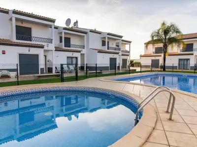 a swimming pool in front of a building at Magnólia AB House by Stay ici Algarve Holiday Rental in Albufeira
