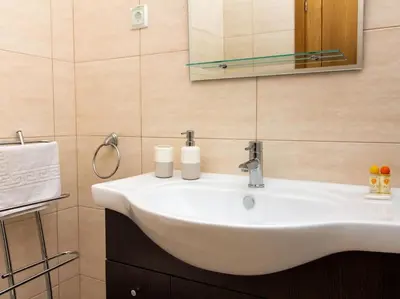 a bathroom with a white sink and a mirror at Magnólia AB House by Stay ici Algarve Holiday Rental in Albufeira