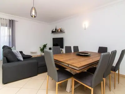 a dining room with a table and a couch at Magnólia AB House by Stay ici Algarve Holiday Rental in Albufeira