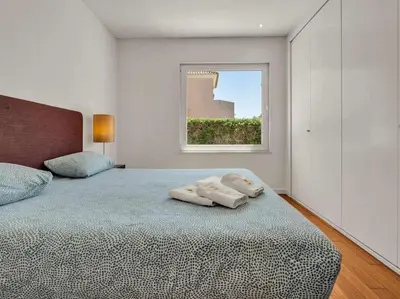 a bedroom with a bed with two towels on it at Villa Laguna 25 by Stay ici Algarve Holiday Rental in Quarteira