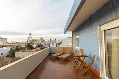 a balcony with a table and chairs and a view at Faro Guest Apartments in Faro