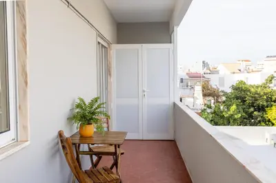 an apartment balcony with a table and a plant at Faro Guest Apartments in Faro
