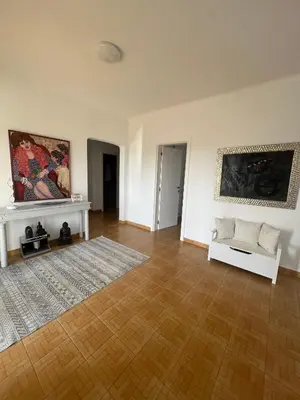 a living room with a white couch and a rug at Casa Amar in Loulé