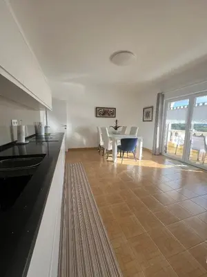 a kitchen and dining room with a table and chairs at Casa Amar in Loulé