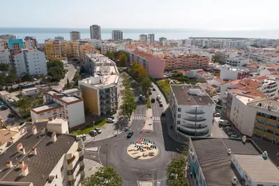 an aerial view of a city with buildings and a street at Roberto Quarteira Central in Quarteira