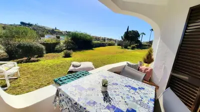 a room with a table and chairs on a balcony at Excellent 1 Bedroom Villa - em Clube Albufeira Garden Village in Albufeira